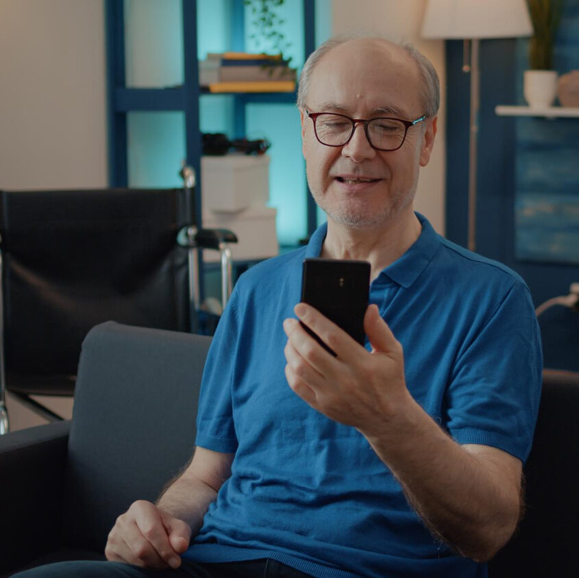 retired-man-holding-smartphone-chat-video-call-with-family-using-online-teleconference-remote-communication-pensioner-having-conversation-with-people-videoconference-meeting